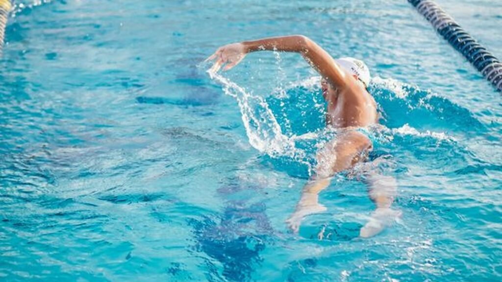 Swimmer in a pool lane wearing one of the best smartwatches for swimming