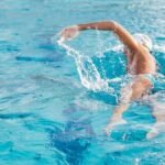Best Smartwatches for Swimming in 2026: 5 Truly Waterproof Picks Swimmer in a pool lane wearing one of the best smartwatches for swimming
