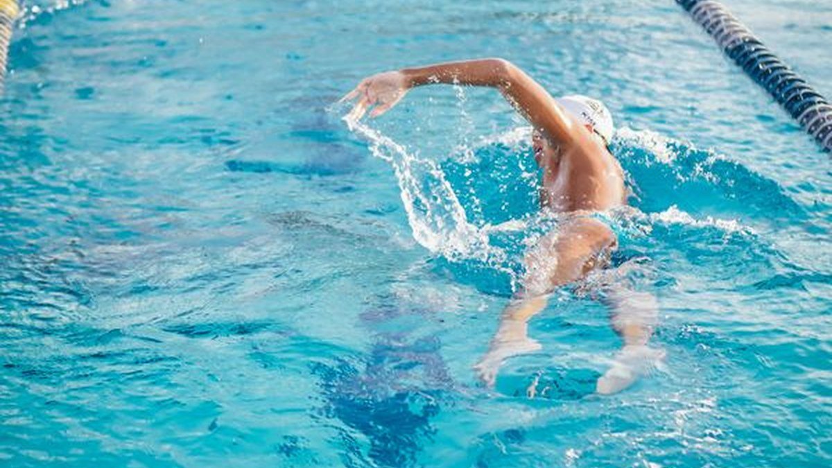 Swimmer in a pool lane wearing one of the best smartwatches for swimming