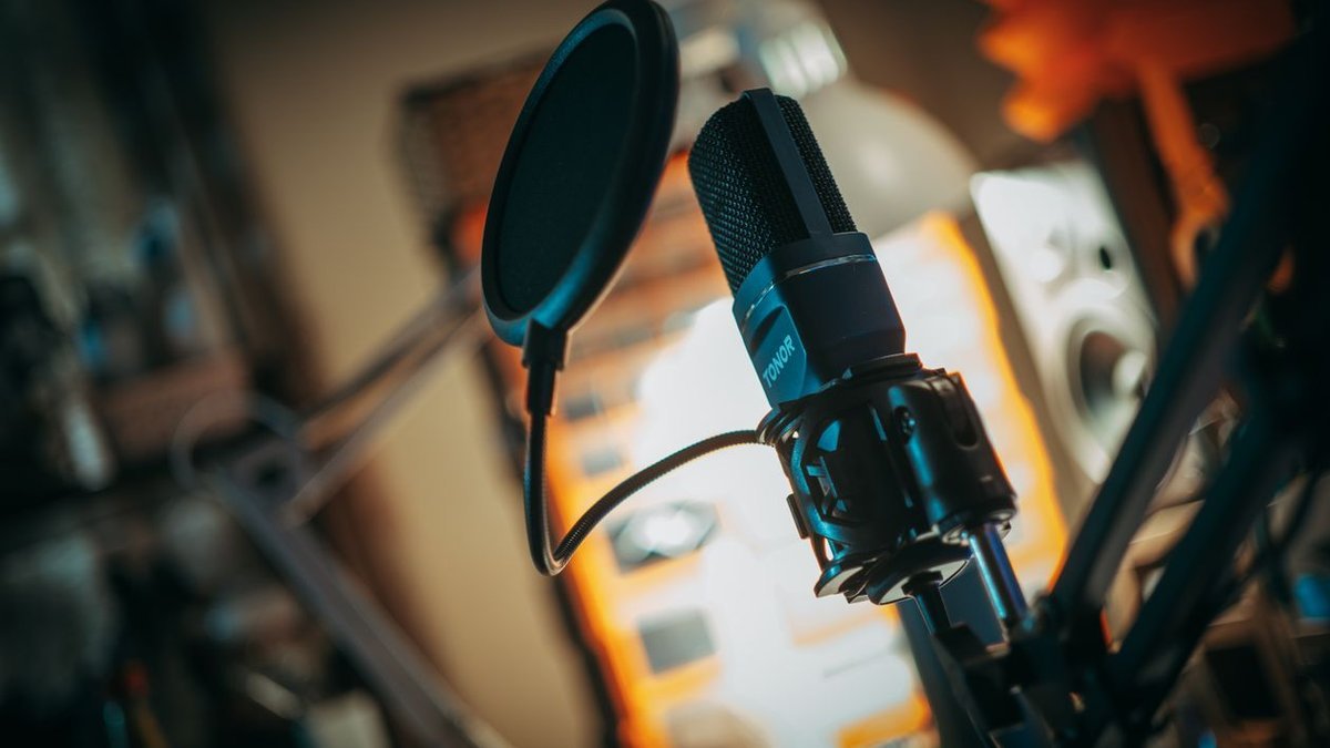 One of the best studio microphones for creators mounted on a boom arm in a home studio