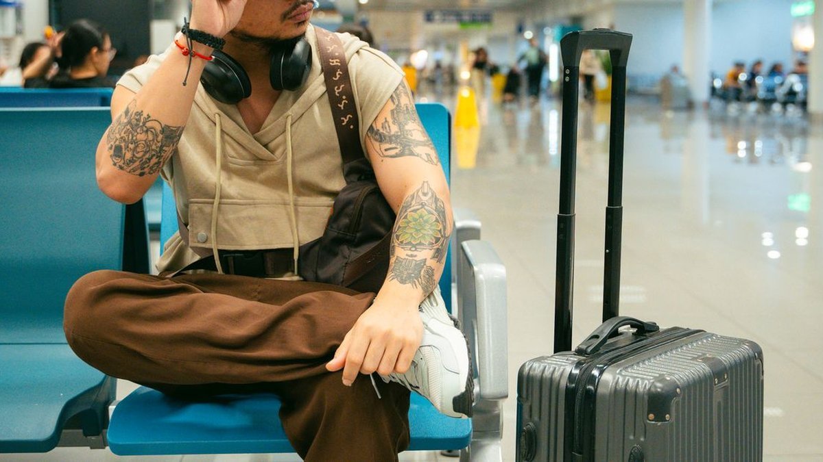 Best tech gifts for travelers 2026 headphones power bank and camera travel flat lay