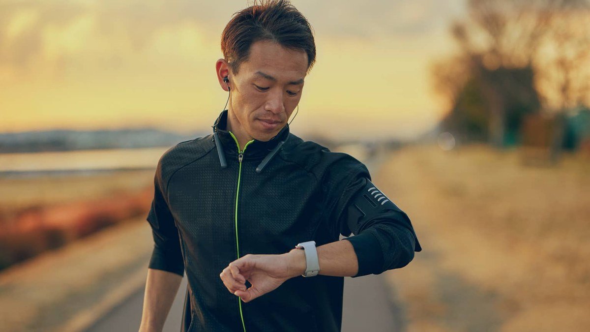 Runner checking one of the best smartwatches for running mid-run