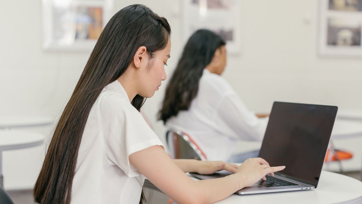 Student typing on a thin lightweight laptop, one of the best laptops for college students