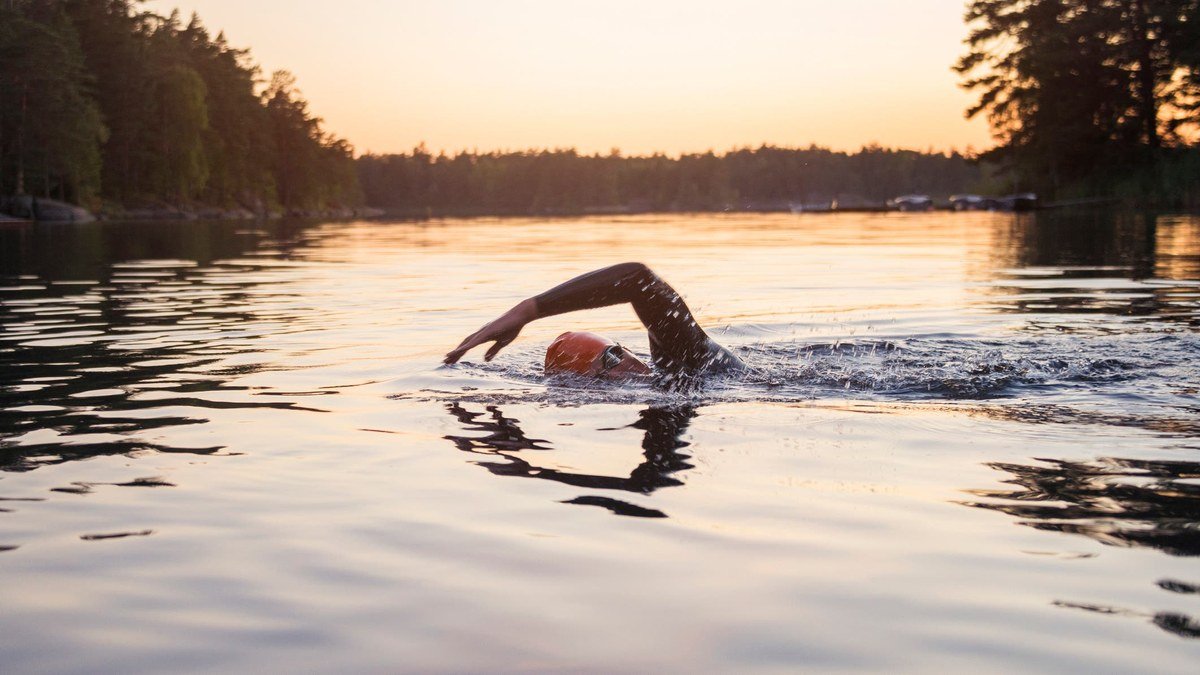 Open-water swimmer wearing a GPS swim watch, best smartwatches for swimming