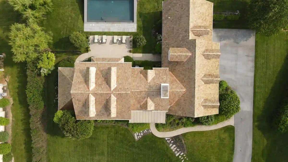 Drone capturing aerial photo of luxury home — best drones for real estate photography 2026