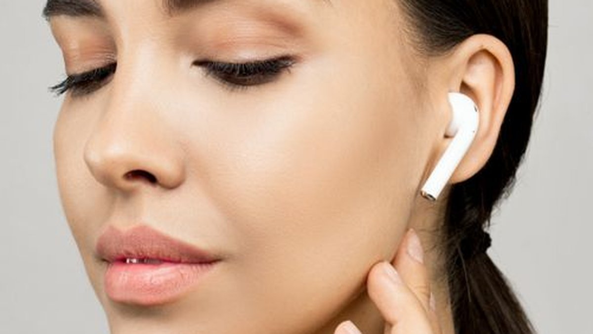 Woman using best tech gifts for women including smartwatch and wireless earbuds 2026