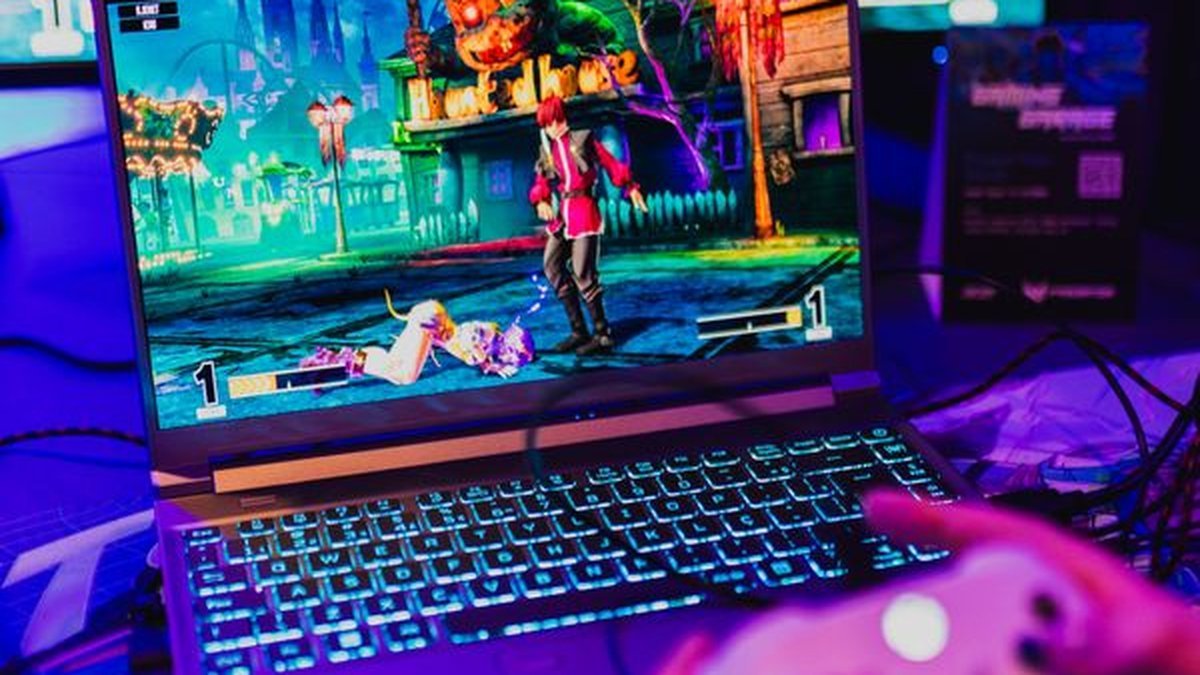 Person playing games on one of the best gaming laptops under 1000 2026