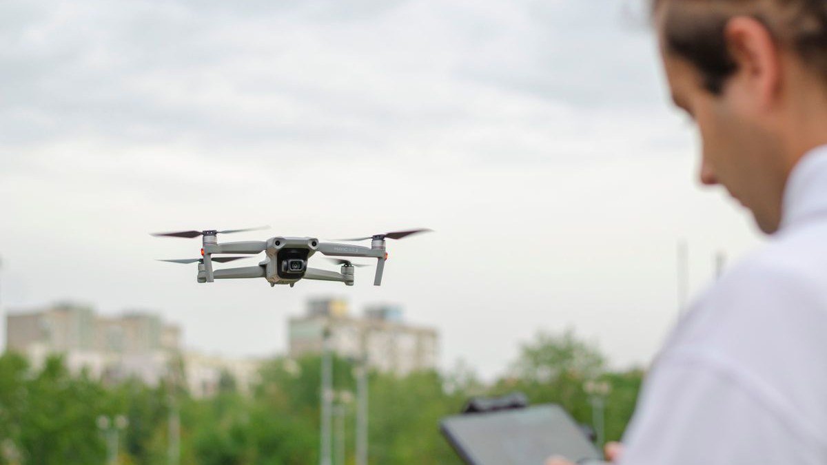 Drone pilot preparing for flight in a park — US drone laws 2026