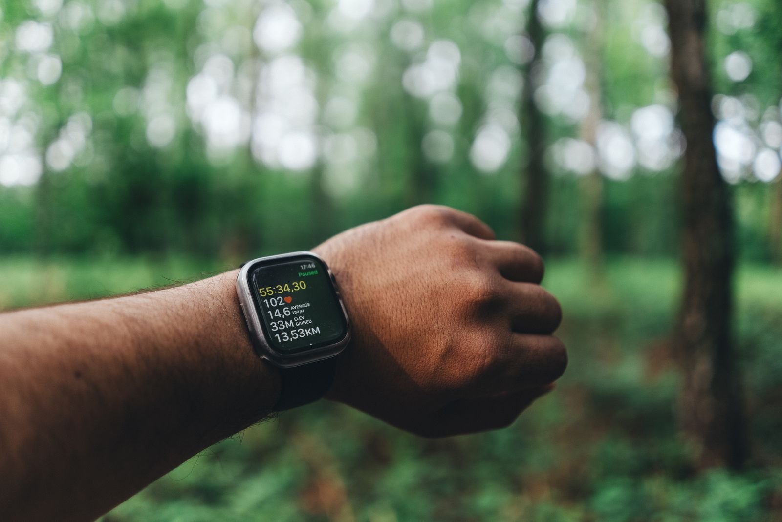 Runner checking smartwatch fitness data — battery and health tracking in our smartwatch comparison